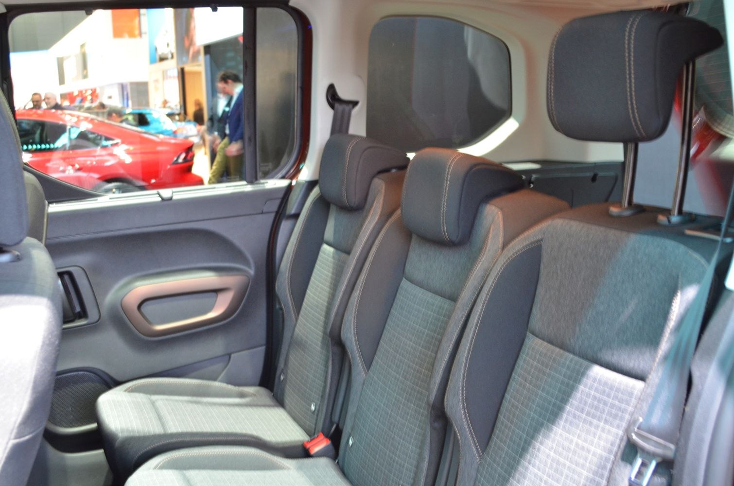 Rear passenger seats with fabric upholstery and adjustable headrests