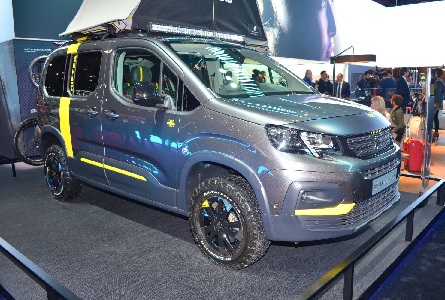 Rugged 4x4 vehicle with off-road tires and roof-mounted light bar