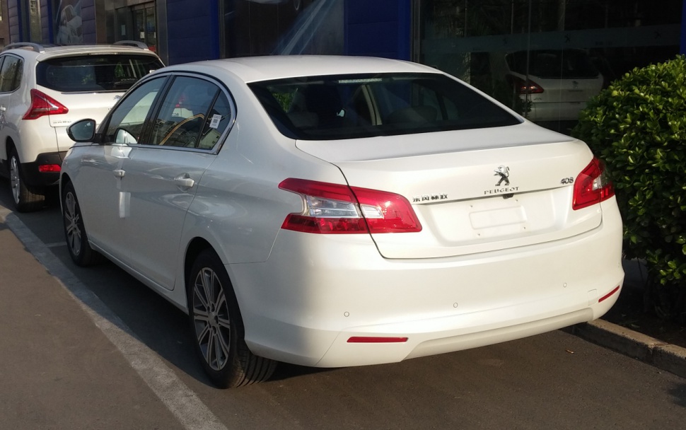 White sedan rear with distinctive taillights and rear bumper design