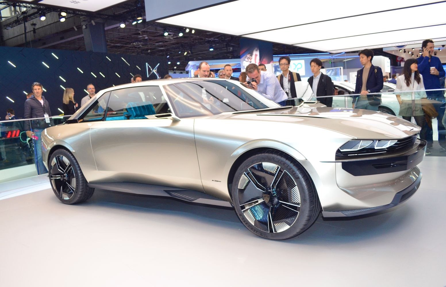 Futuristic retro-styled car with aerodynamic shape and unique wheel design