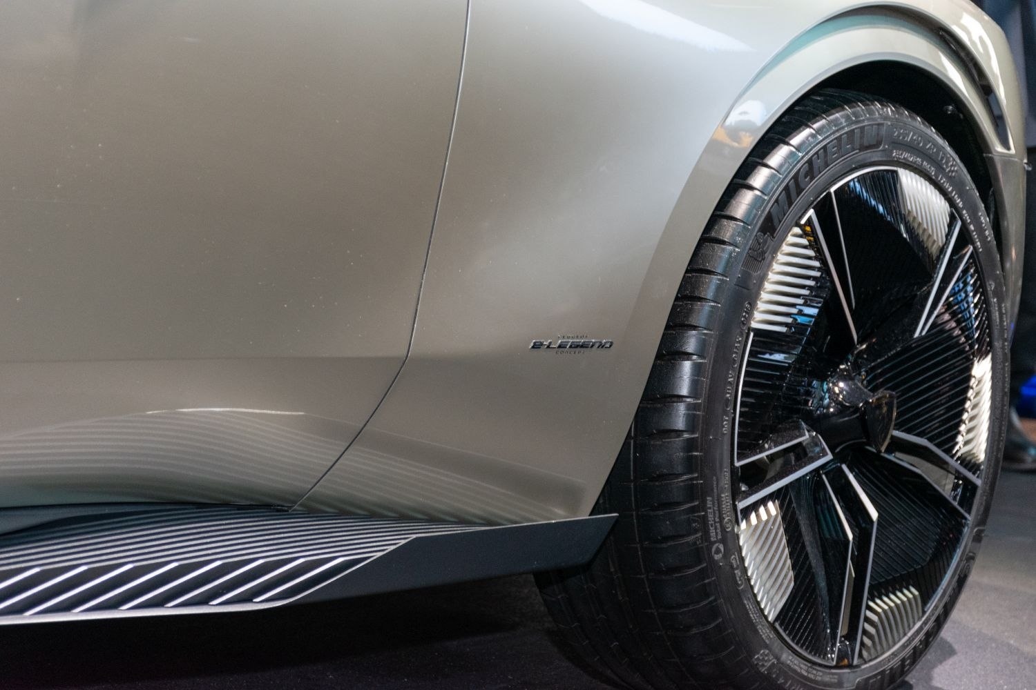 Close-up of wheel and side panel with logo and modern alloy design