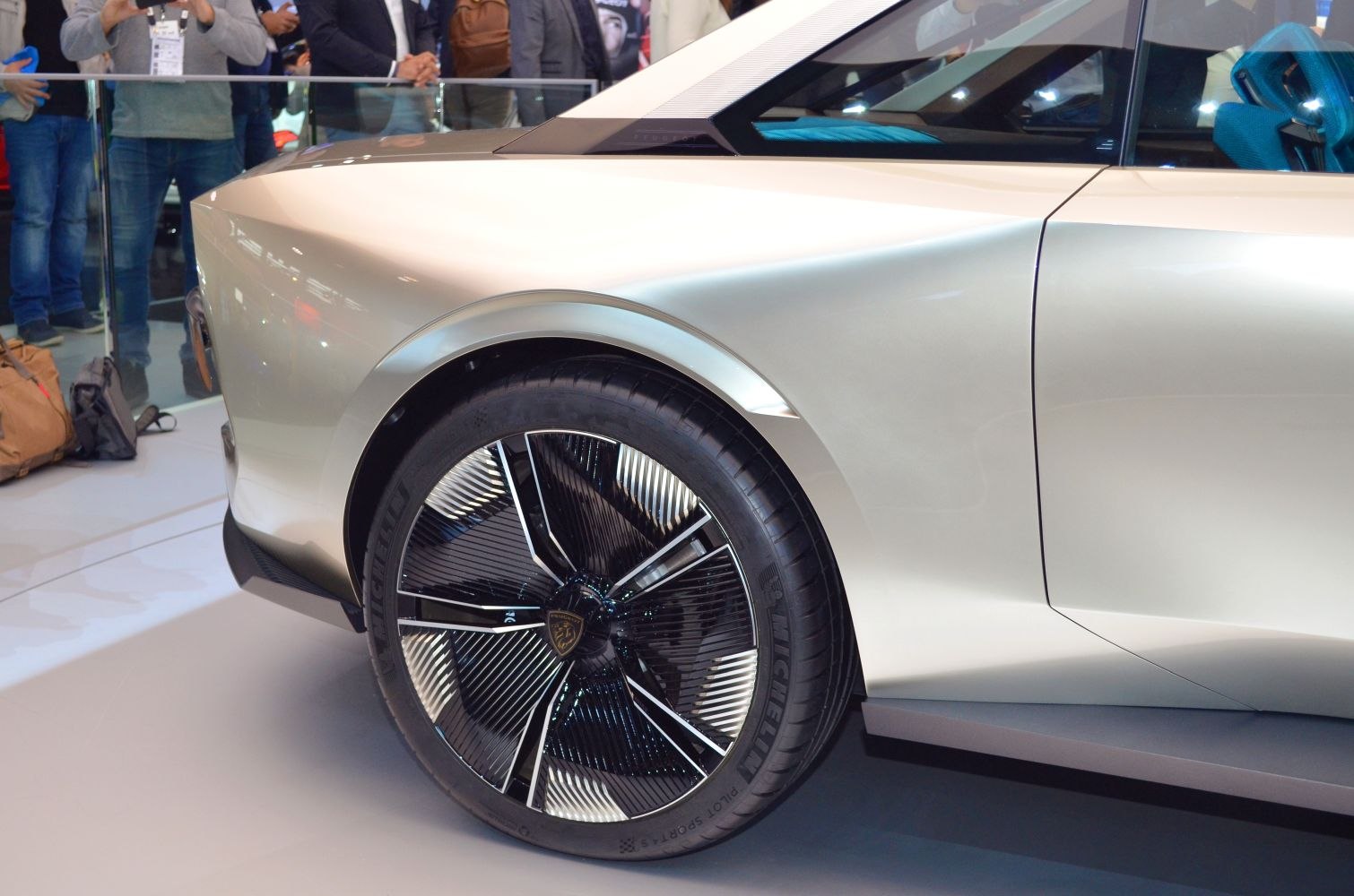 Rear wheel with black alloy rim and sleek body panel design