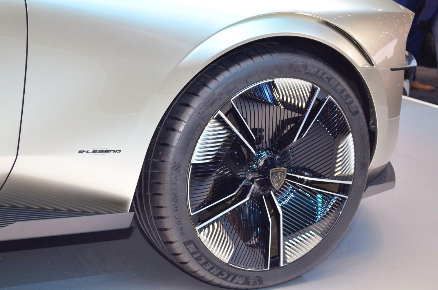 Close-up of a sleek wheel with intricate spokes and a fender badge