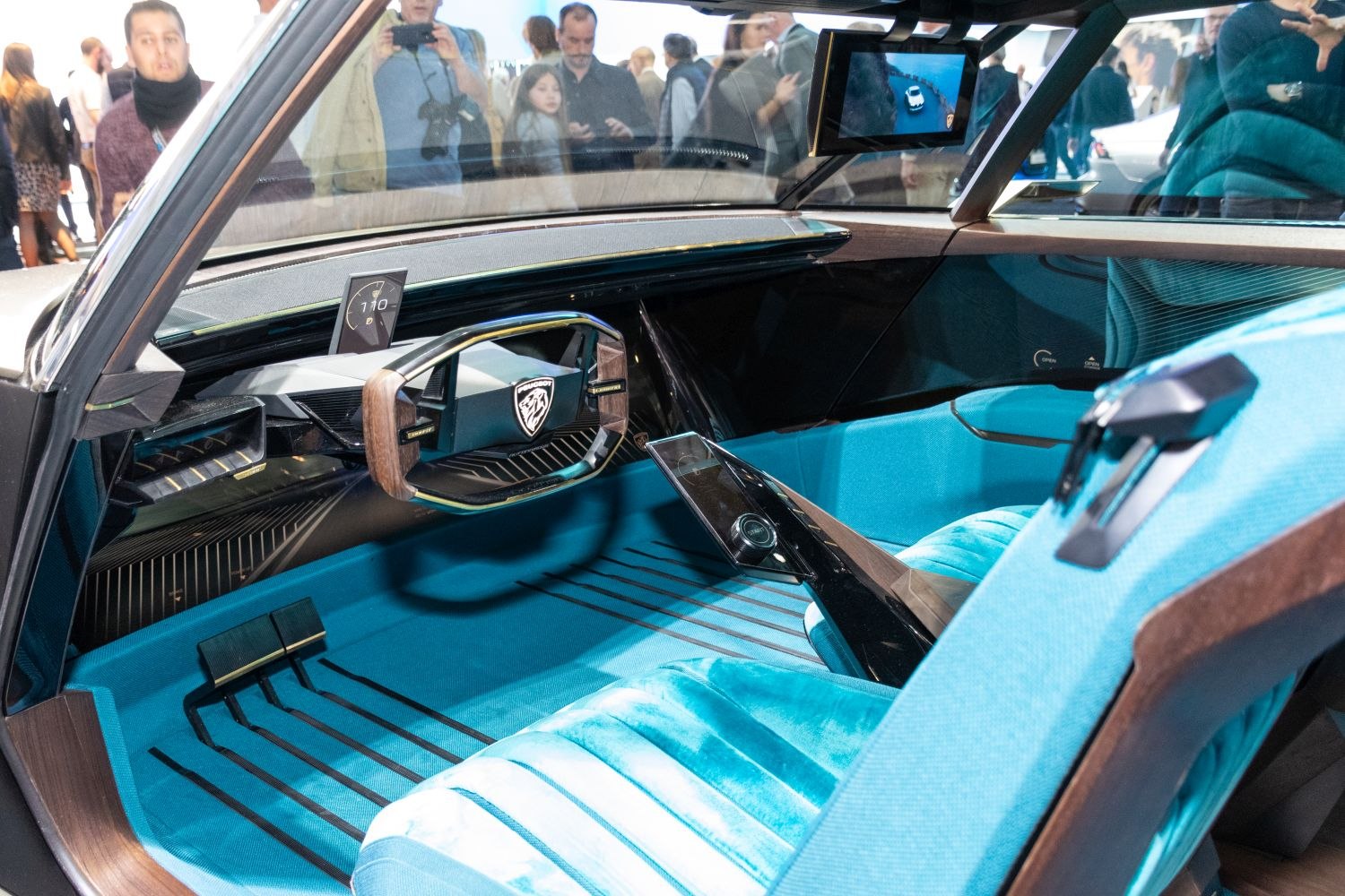 Blue car interior with advanced digital dashboard and unique steering wheel design
