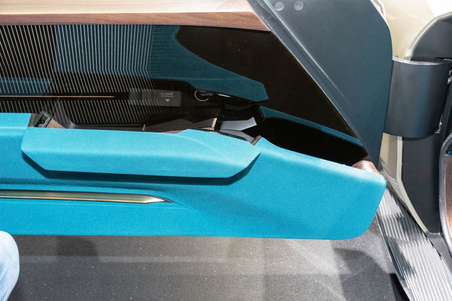 Turquoise fabric door panel with sleek integrated storage and handle