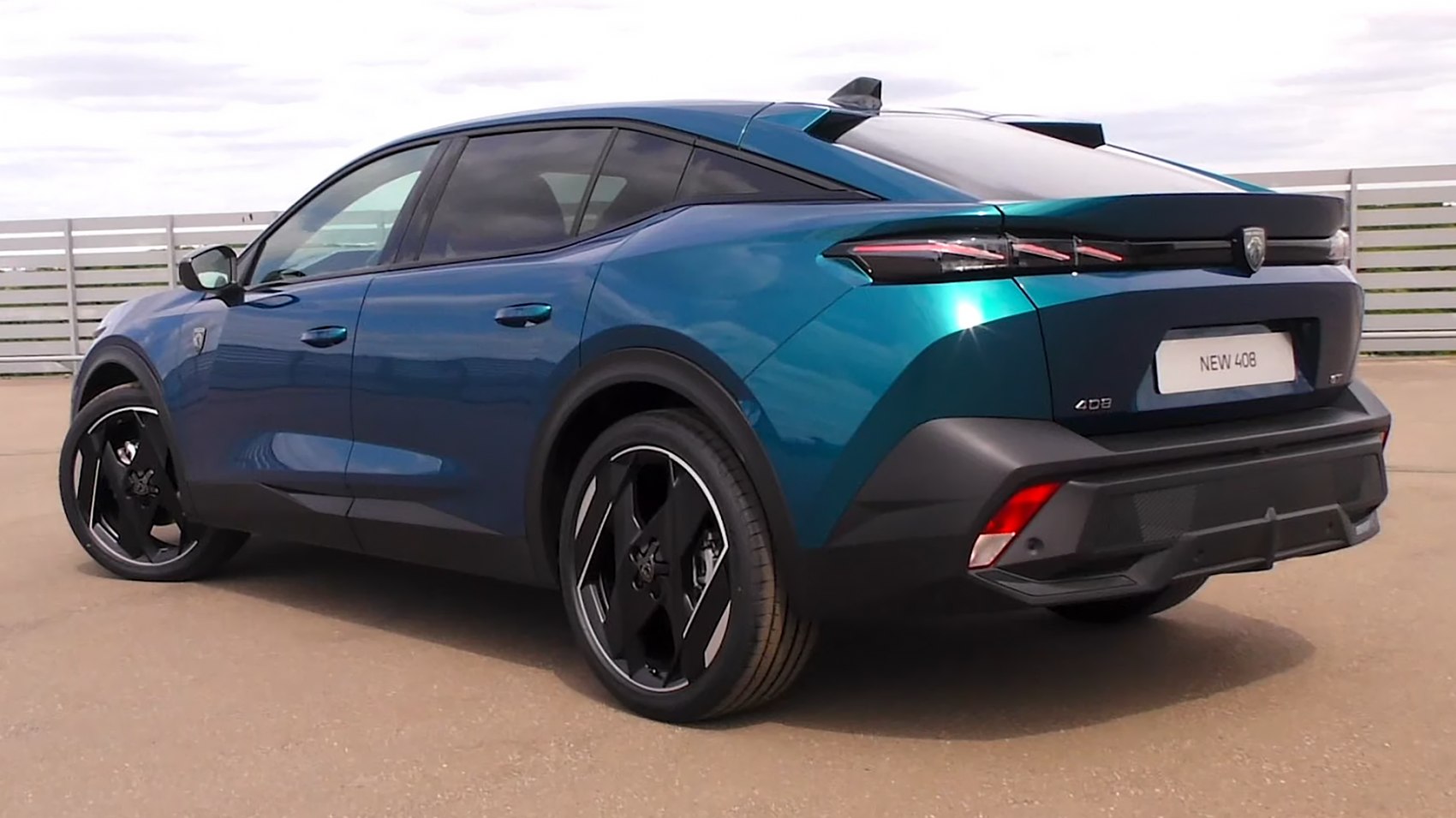 Rear side view of 2023 crossover with black alloy wheels and sleek design