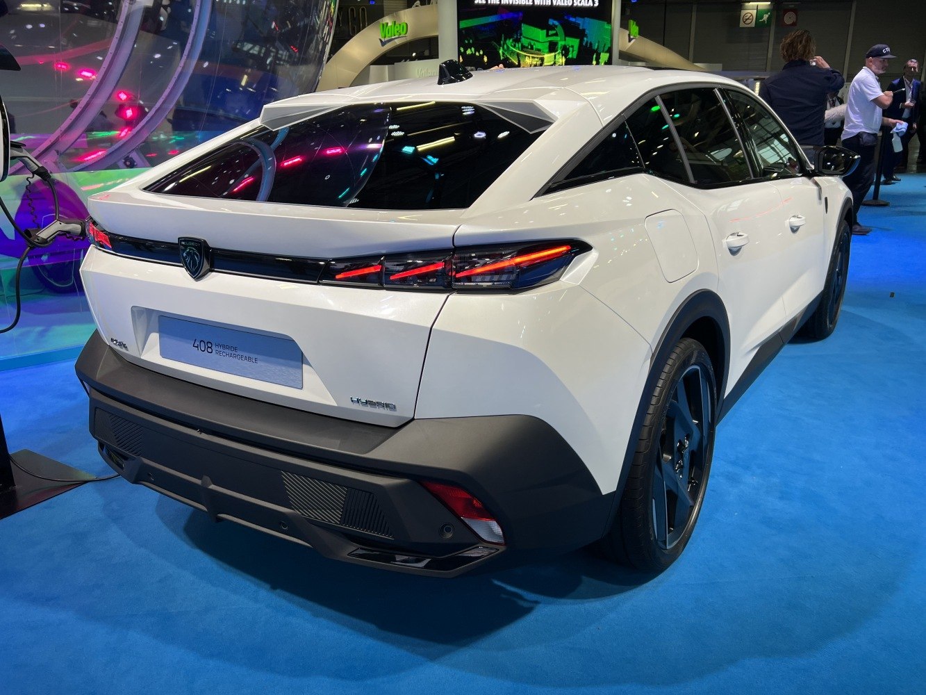 Rear view of modern crossover with sleek taillights and hybrid charging port