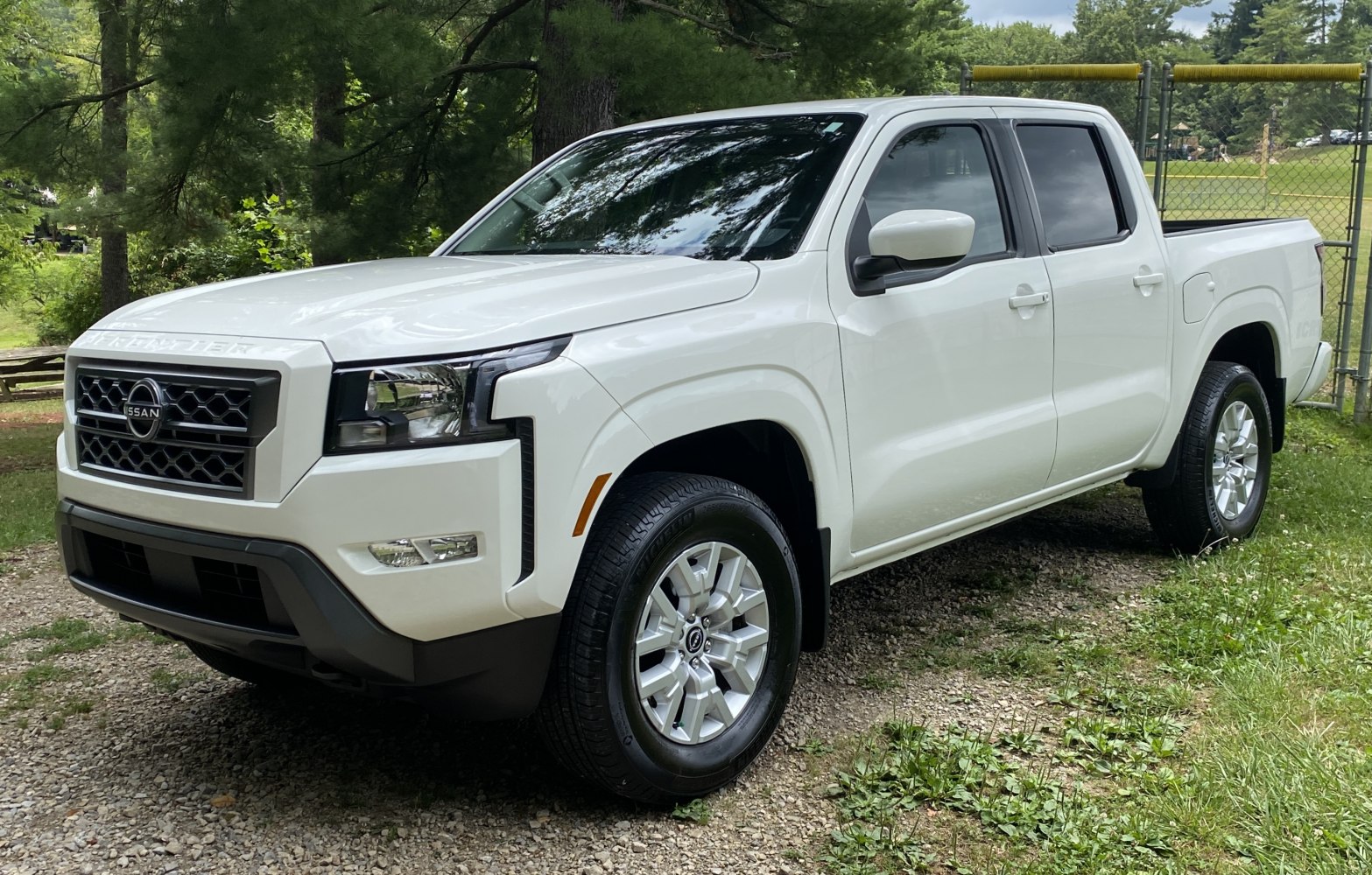 Front and side view of a modern crew cab pickup truck with bold grille and rugged styling