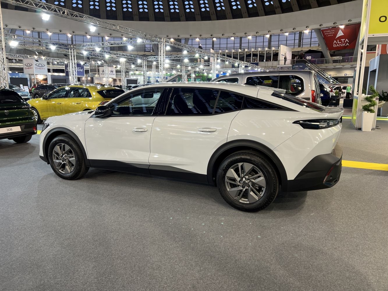 Sleek modern coupe-SUV side profile with black trim and alloy wheels