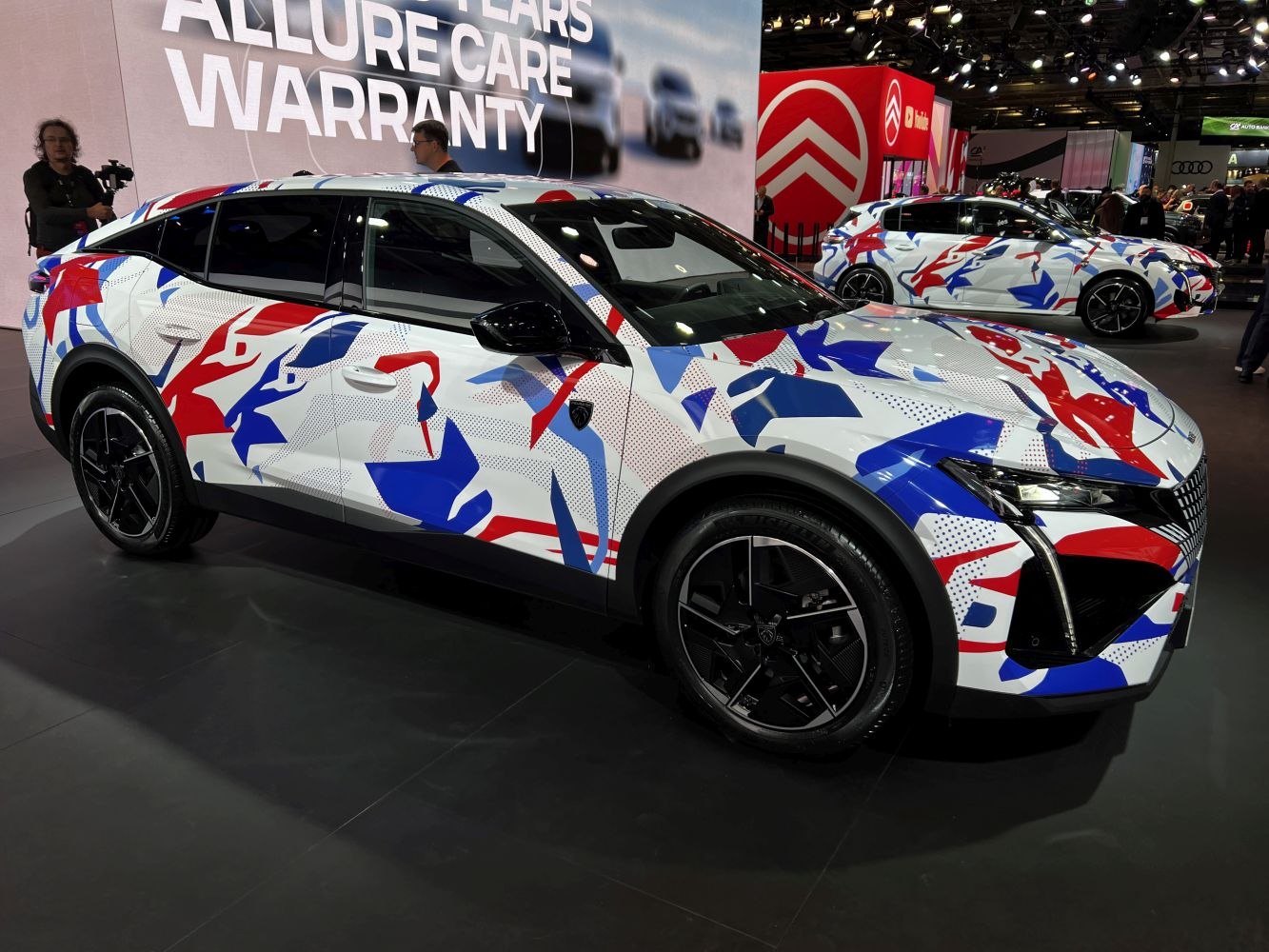 Modern crossover with camouflaged abstract red, blue, white pattern and sharp front LED lights