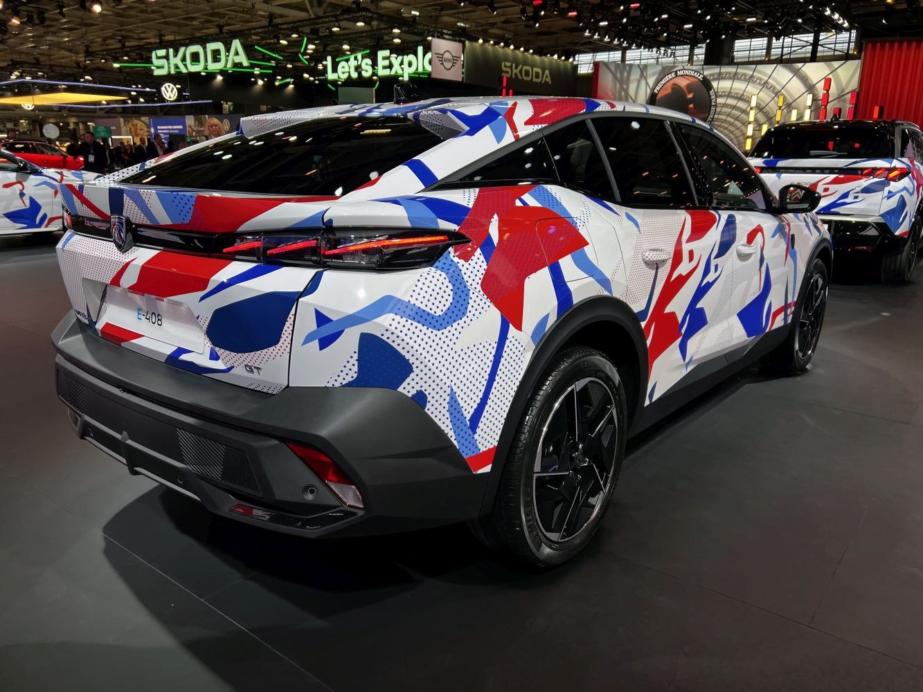 Rear and side view of a crossover with bold red, white, and blue wrap and sharp taillights