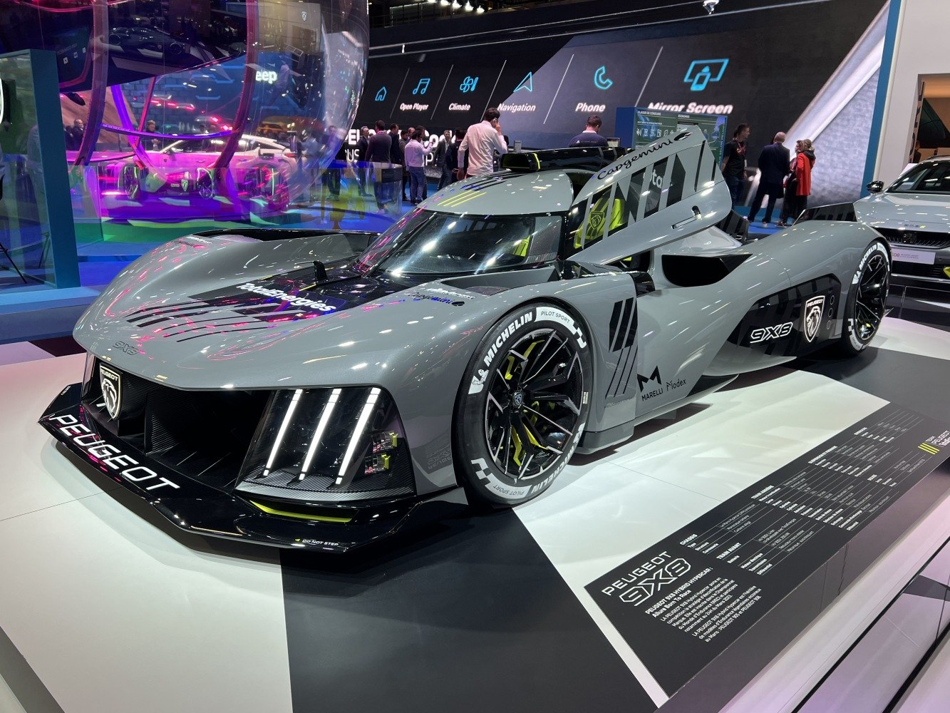 Futuristic racing prototype with aerodynamic design and illuminated front lights