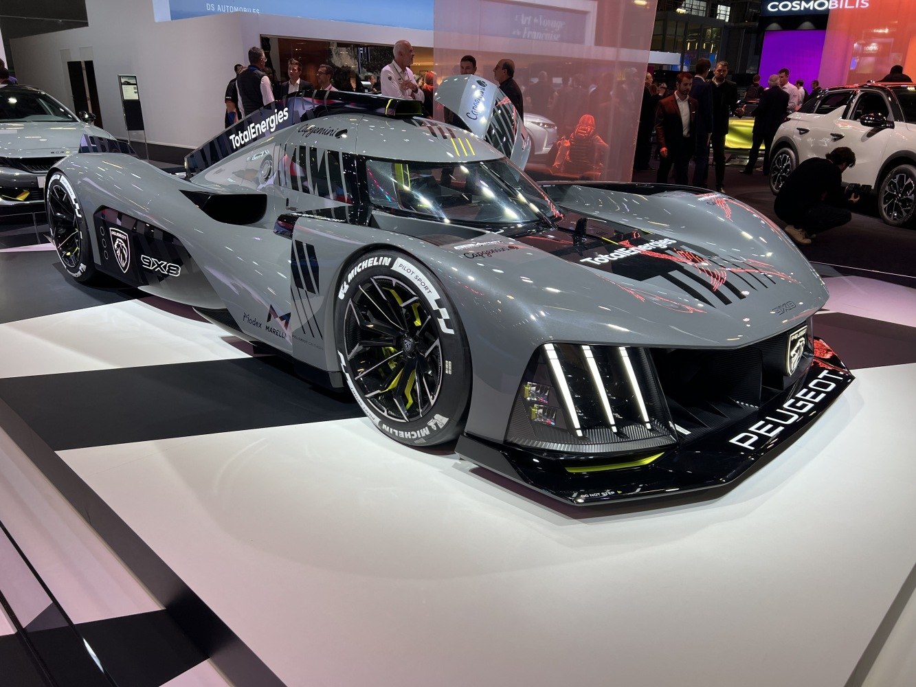 Aerodynamic hybrid racing prototype with advanced lighting and carbon fiber wheels.