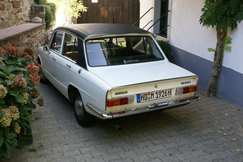 Rear view of vintage sedan with vinyl roof and chrome bumper