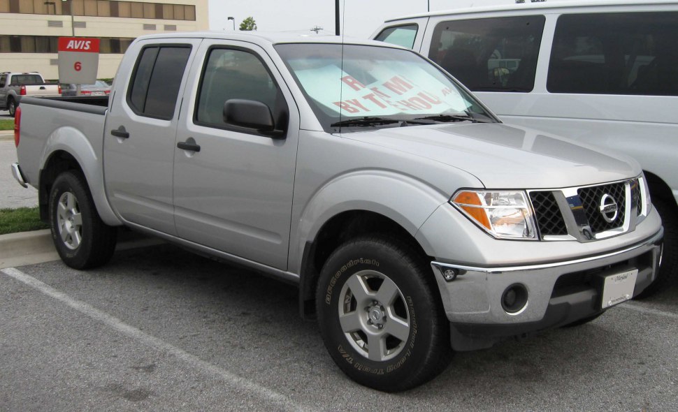 Silver four-door pickup truck with distinct grille and robust tires