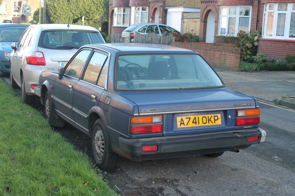 Retro 1980s sedan rear view with rectangular tail lights and boxy body.
