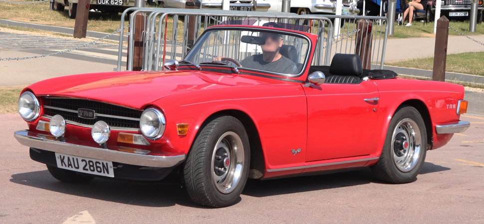 Red convertible with twin round spotlights and chrome bumper
