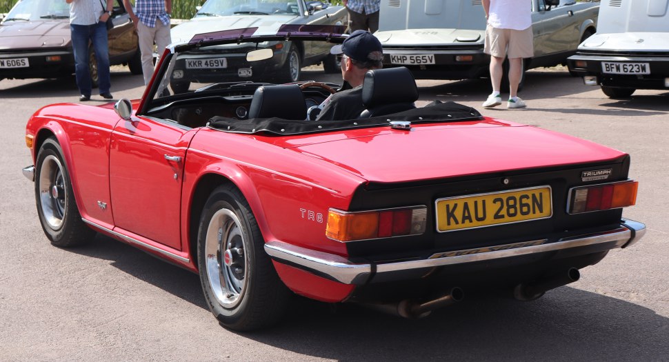 Red convertible classic car rear view with prominent rear lights and license plate