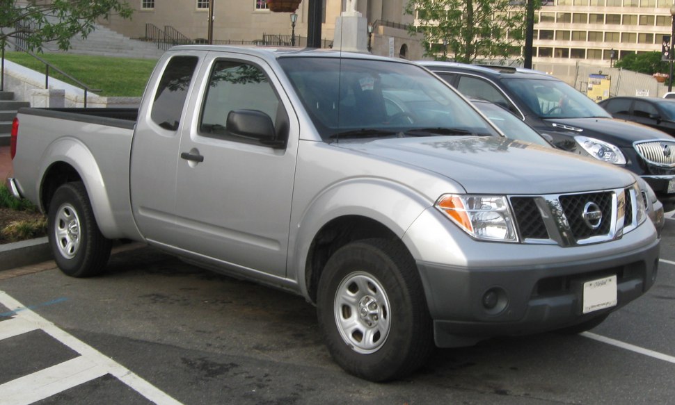 Silver mid-size pickup with extended cab and rugged exterior