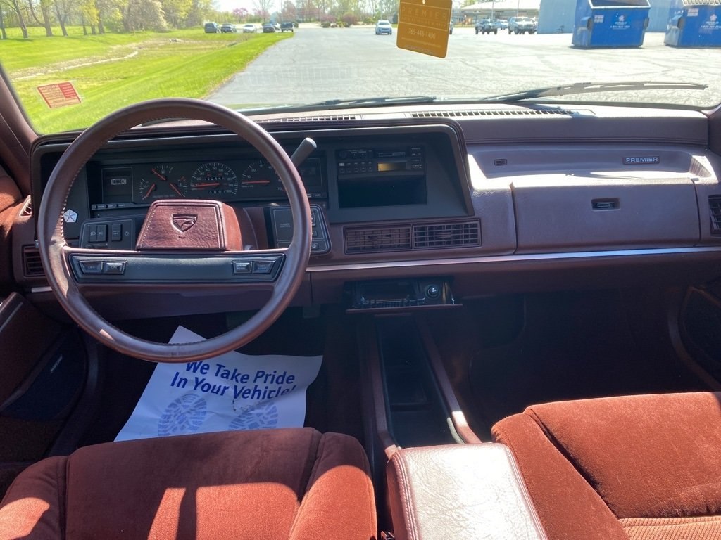 Vintage dashboard and steering wheel with control panel.