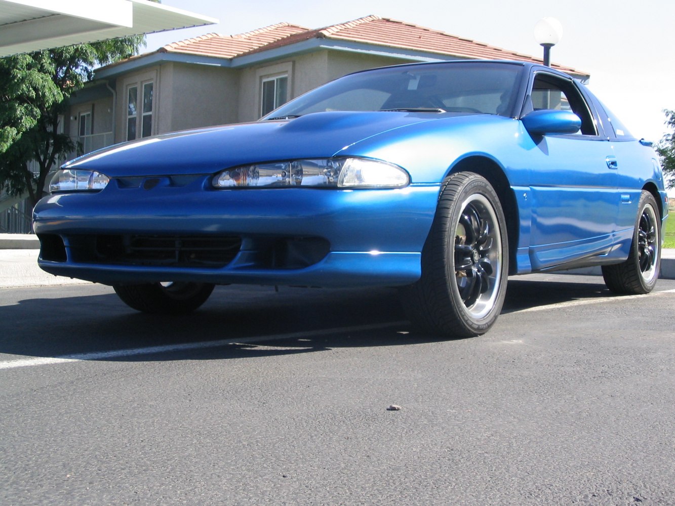 Front angled view with sleek headlights and black alloy wheels