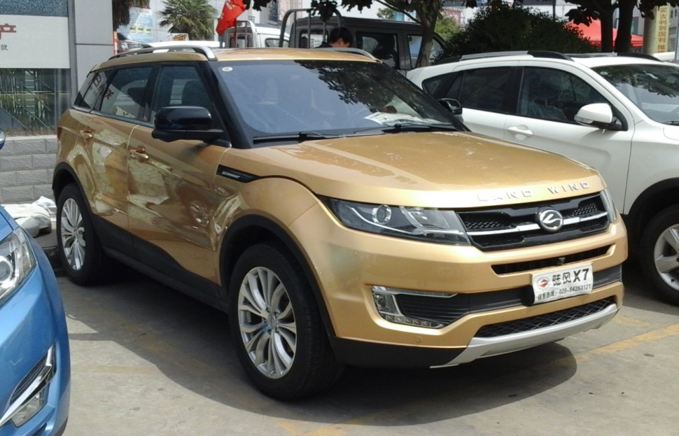 Gold SUV front side with roof rails and alloy wheels