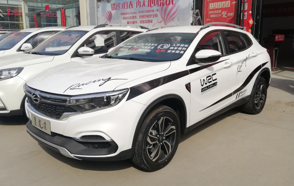 White SUV with WRC racing decals and black alloy wheels