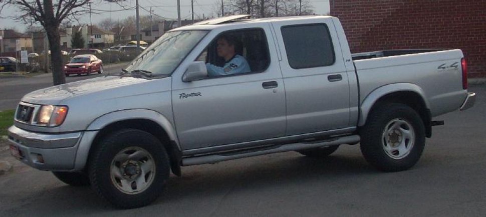 Silver four-door extended cab pickup truck with 4x4 drivetrain.