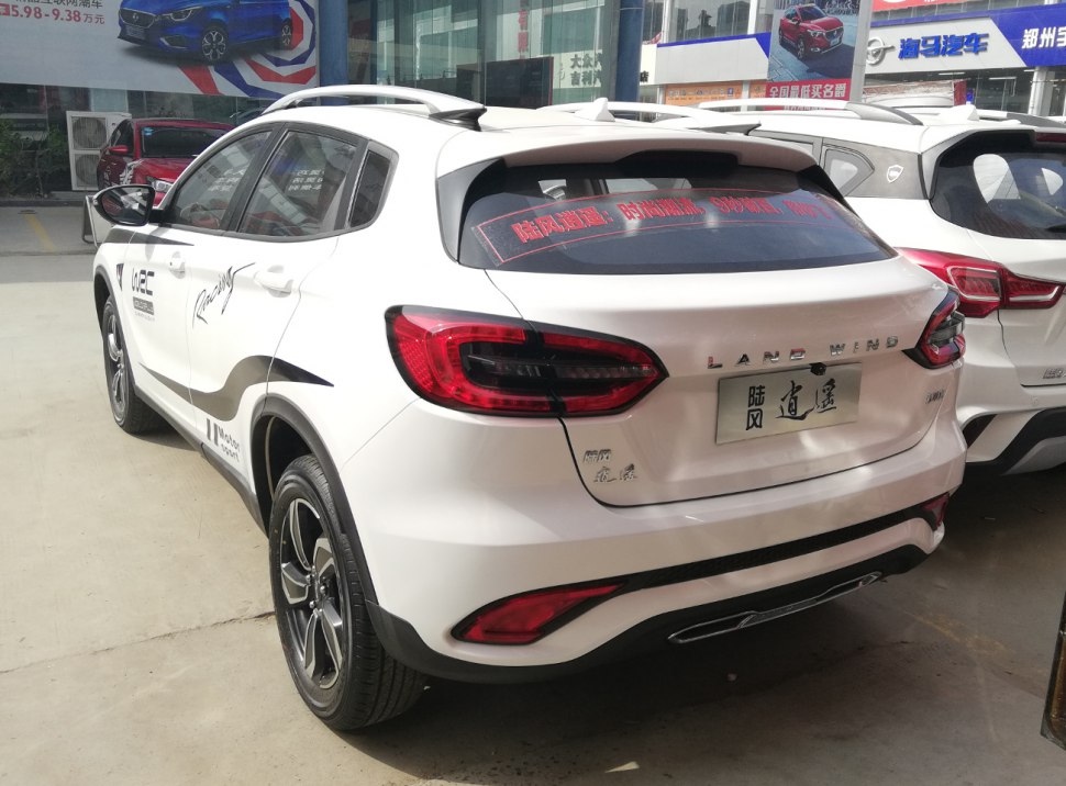 Rear and side view of sporty SUV with distinctive taillights and white body