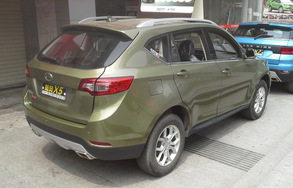 Rear side view of SUV with taillights and alloy wheels.