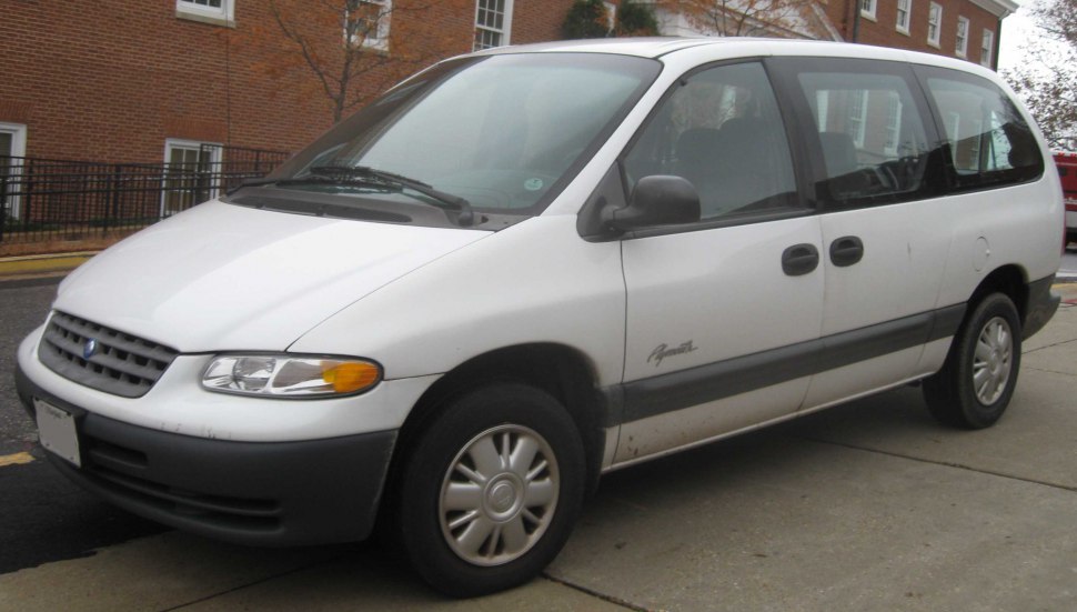 White minivan front side view with sliding doors and hubcap wheels