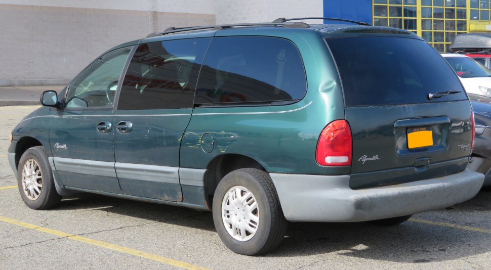 Rear and side view of a late 90s minivan with sliding doors and tinted windows