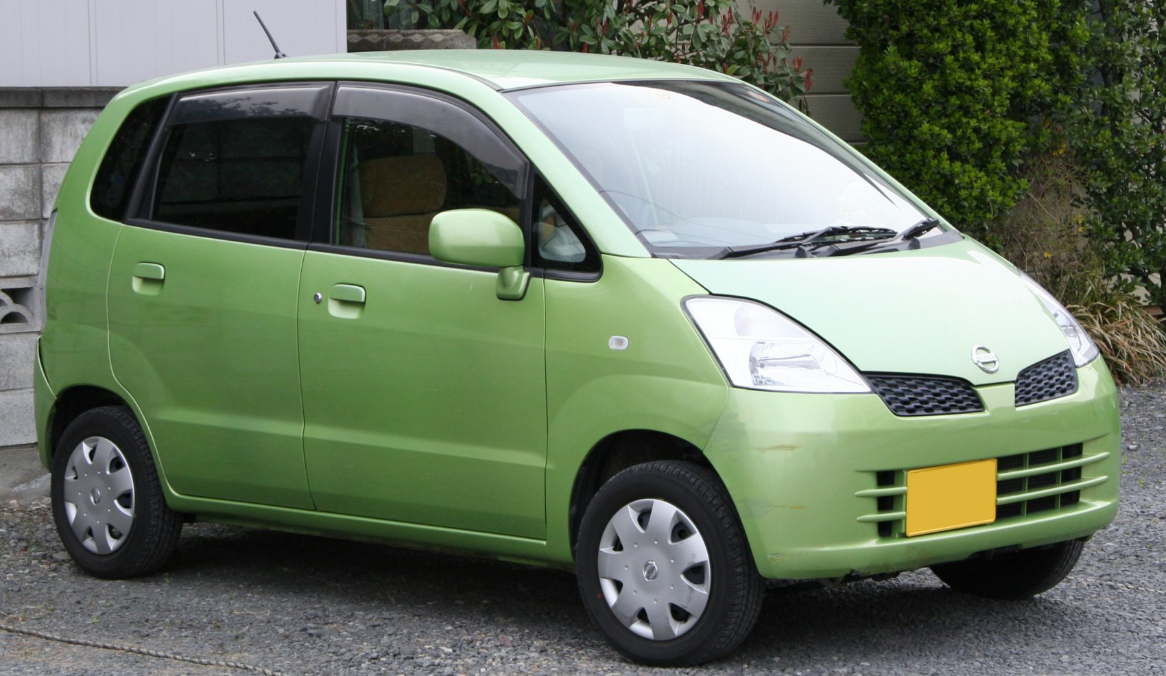 Compact green hatchback with distinctive front grille and headlights