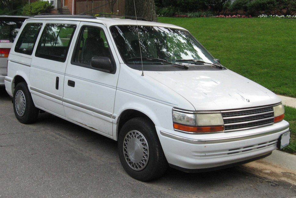 White minivan front side with sliding door and classic 1990s styling