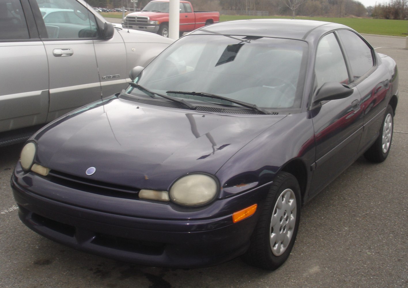 Front and side view with oval headlights and compact sedan shape