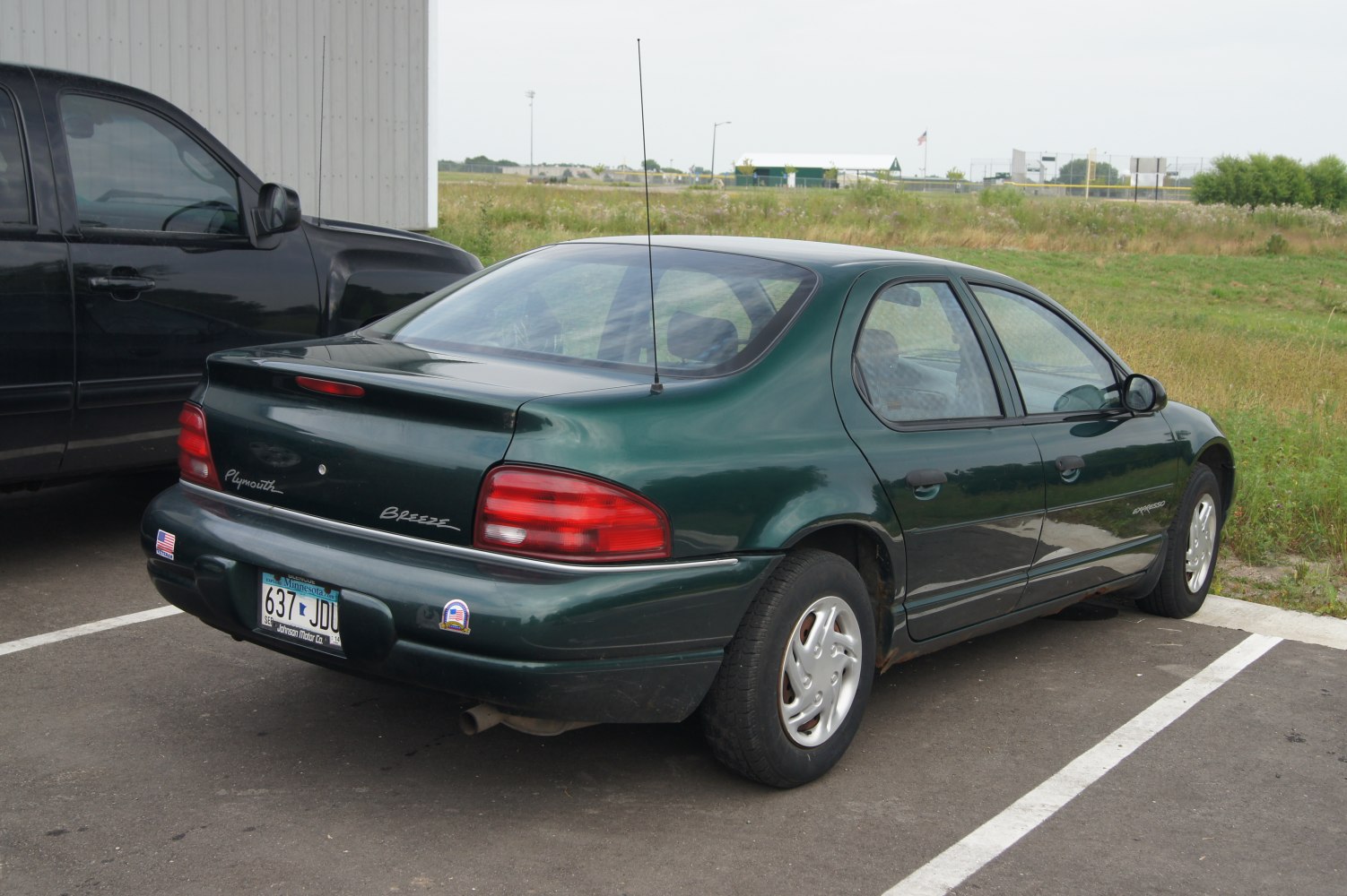 Rear view of a sedan with rounded tail lights and subtle spoiler