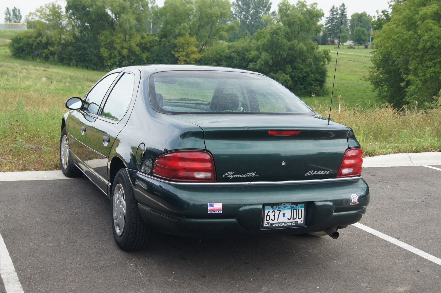 Rear view of a classic 1990s sedan highlighting trunk and taillight design