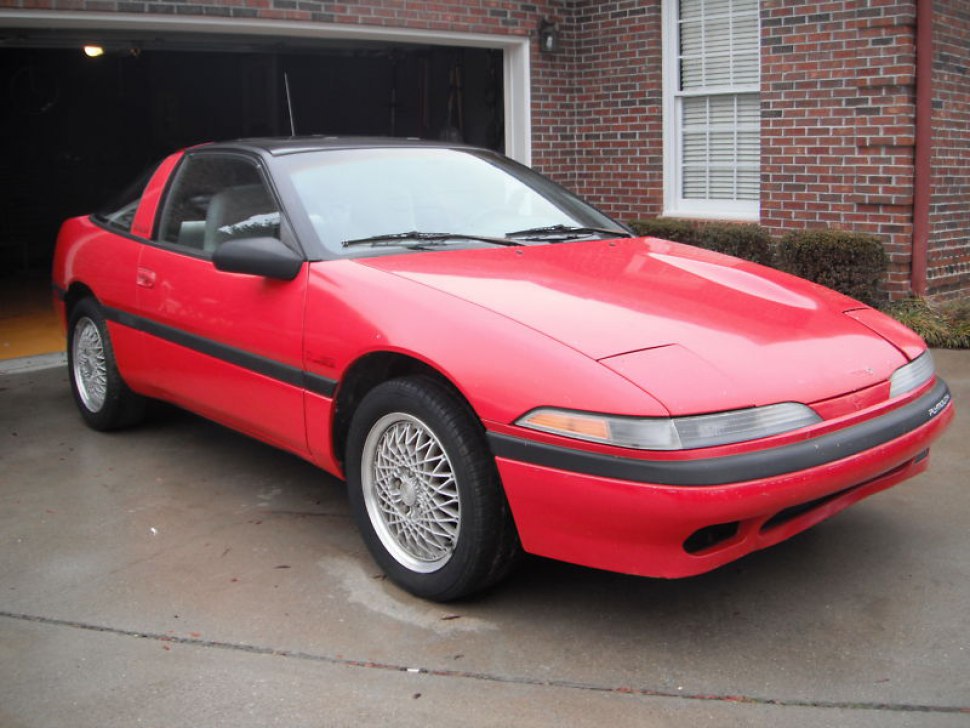 Red coupe with pop-up headlights and alloy wheels