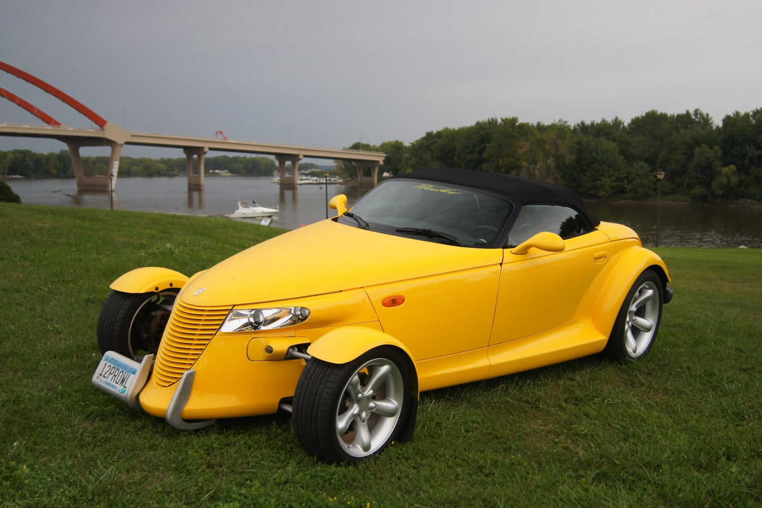Yellow convertible with exposed front wheels and unique retro fenders