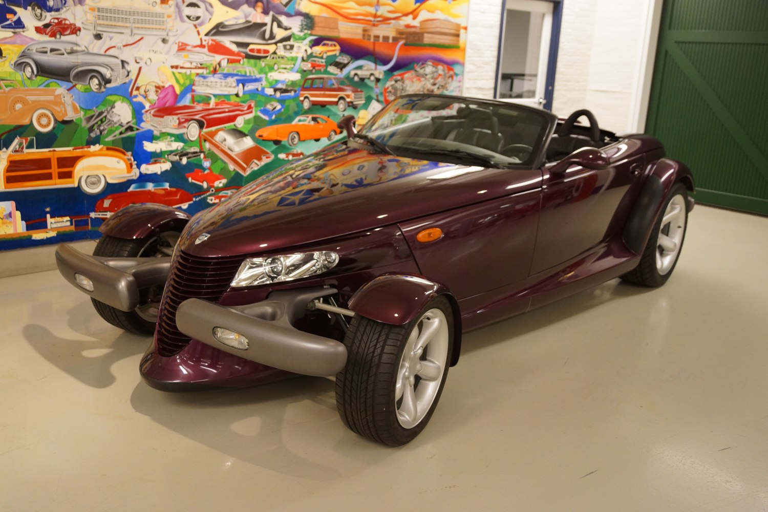 Retro-futuristic open-top convertible with exposed front wheels and unique fenders