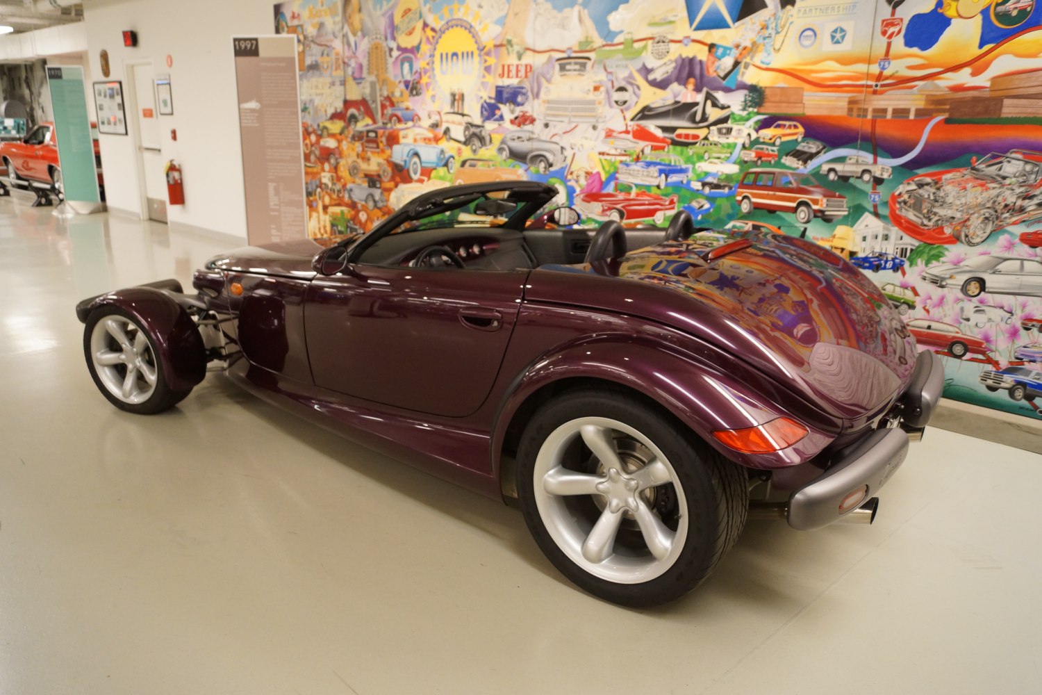 Retro roadster with open front wheels and convertible body.