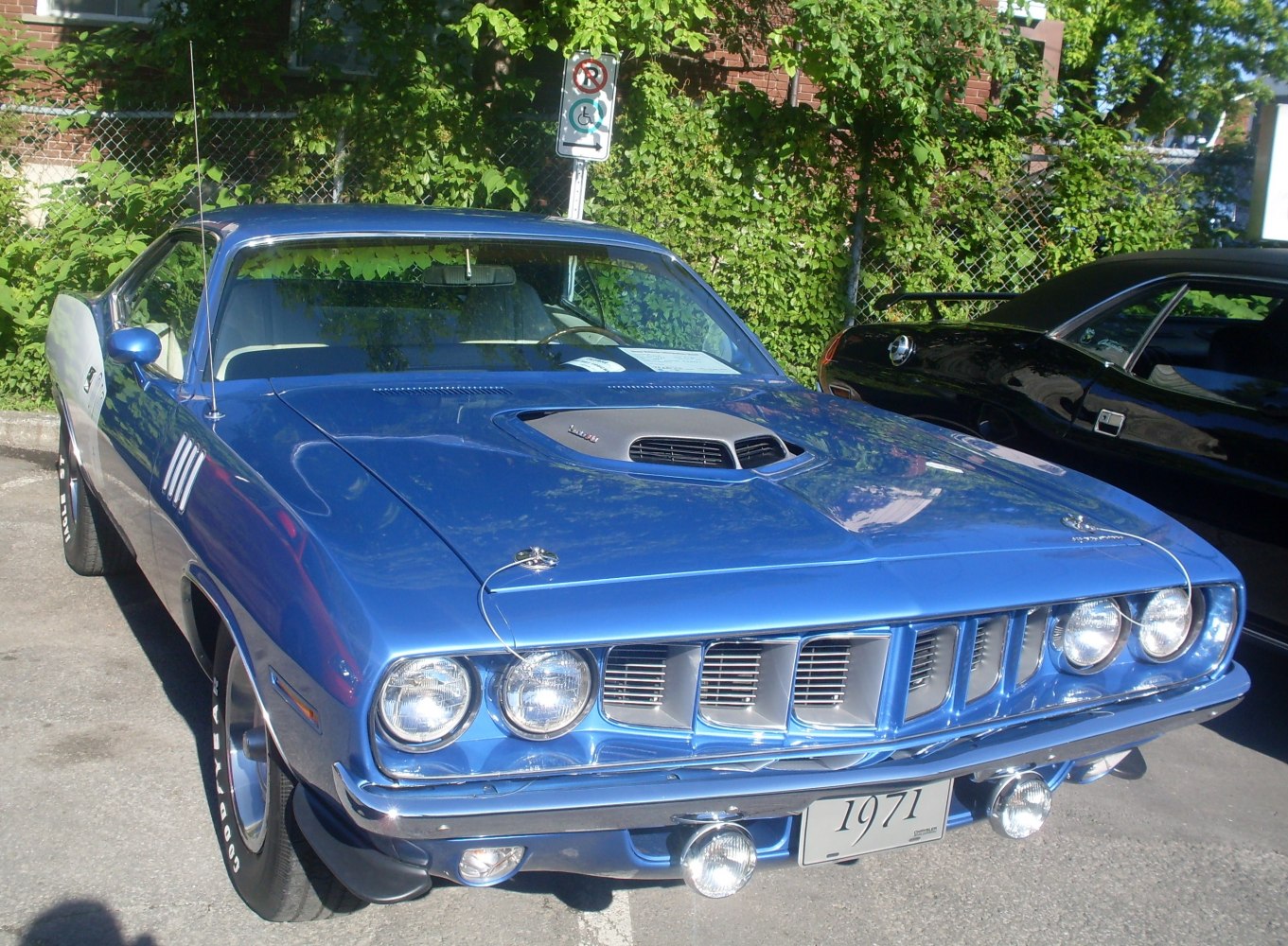 Front view showing quad headlights, grille, and hood scoop.