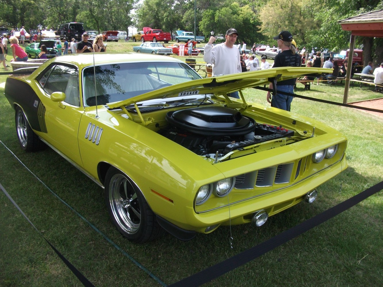 Yellow classic muscle car with open hood and Shaker hood scoop.