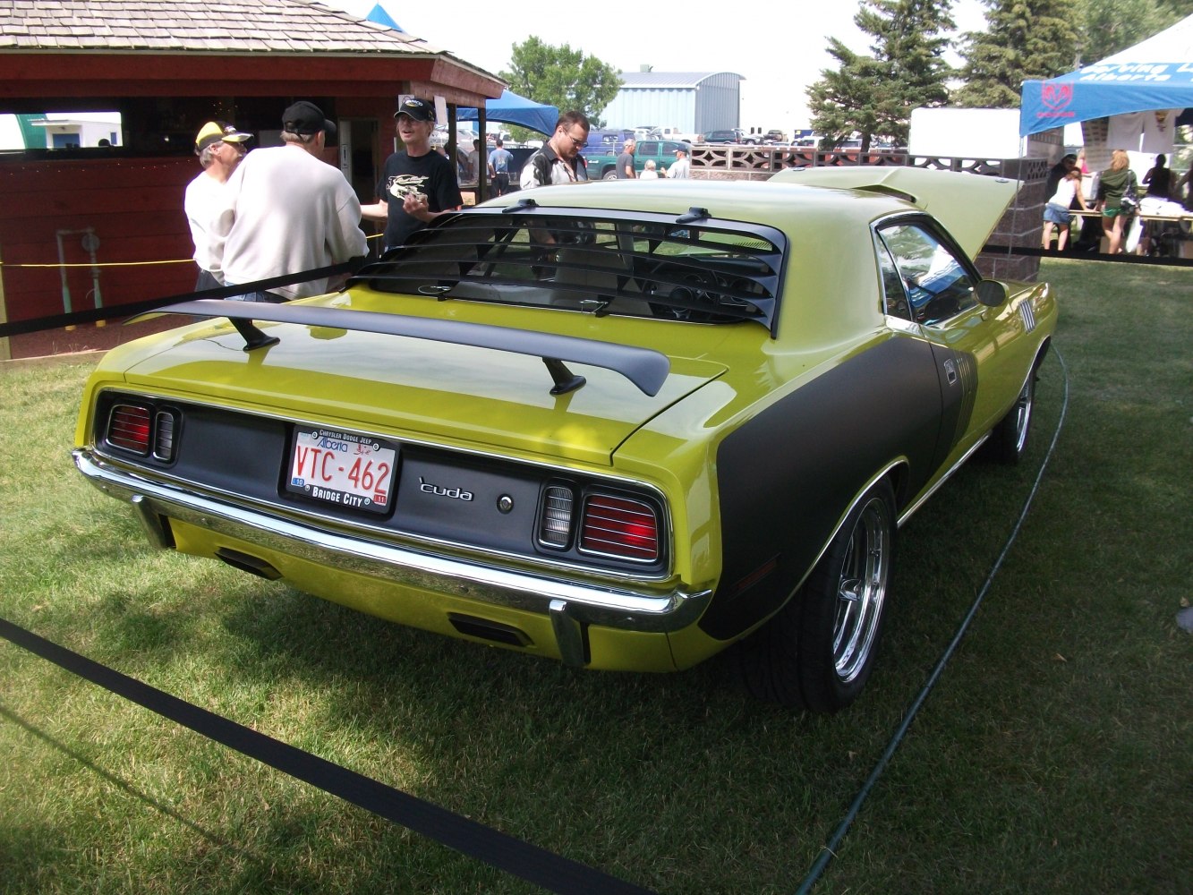 Rear view of classic muscle car with spoiler and window louvers