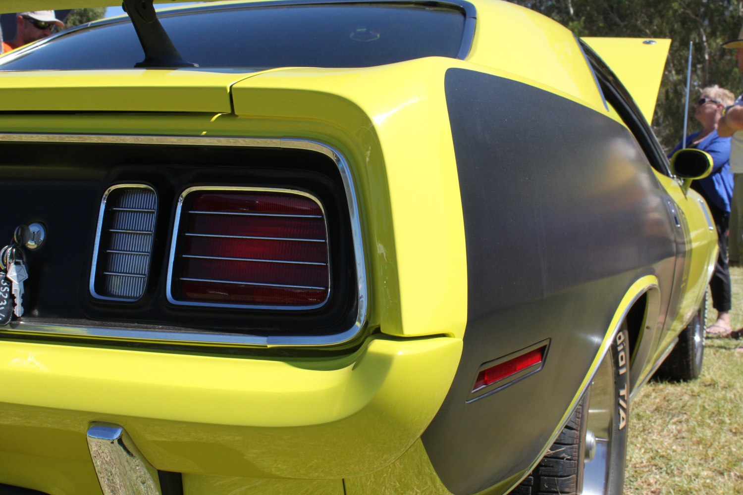 Rear tail light and black matte side panel with yellow paint