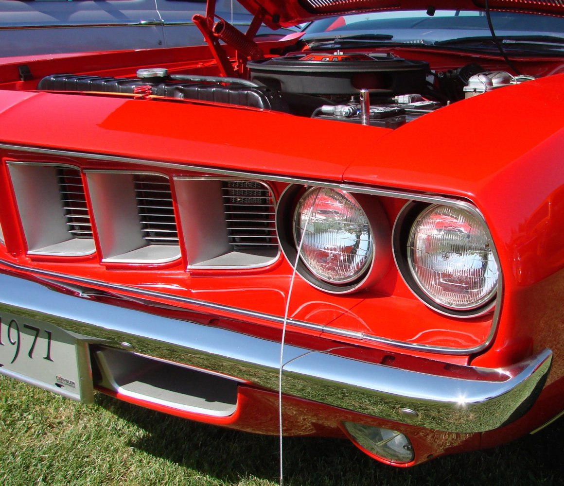 Close-up of front grille with dual round headlights and chrome bumper.