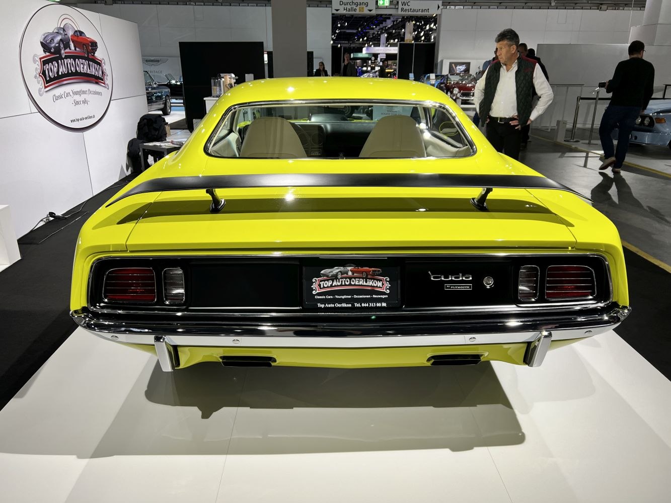 Yellow muscle car rear with black spoiler and classic tail lights