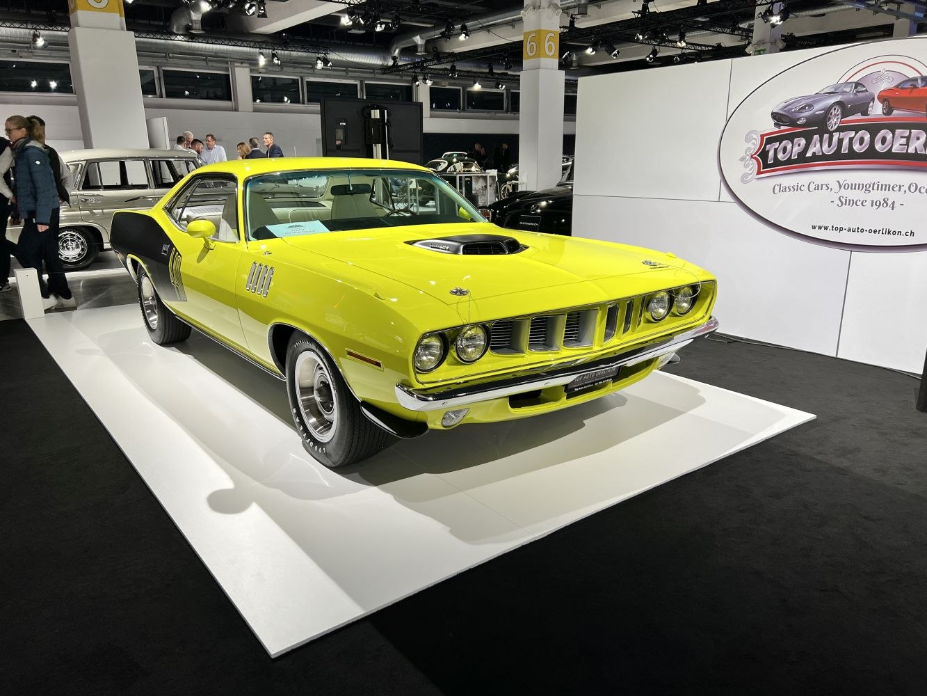 Yellow muscle car with hood scoop and black rallye stripes