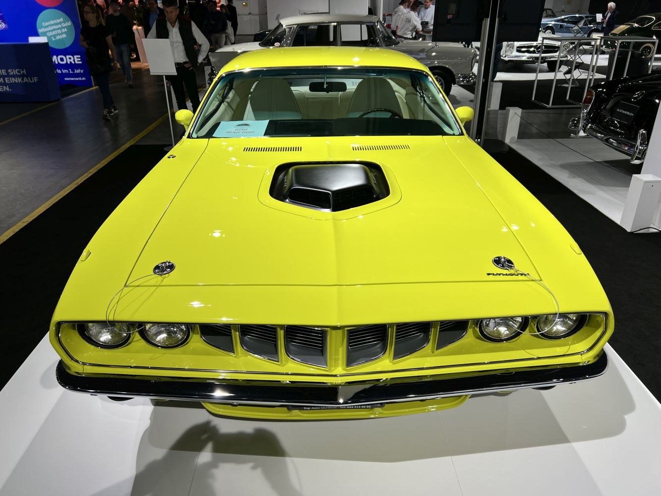 Yellow car front with hood scoop and distinctive grille
