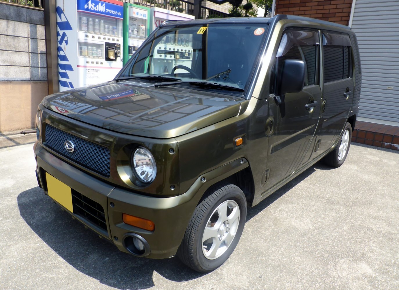 Compact boxy SUV with round headlights and alloy wheels